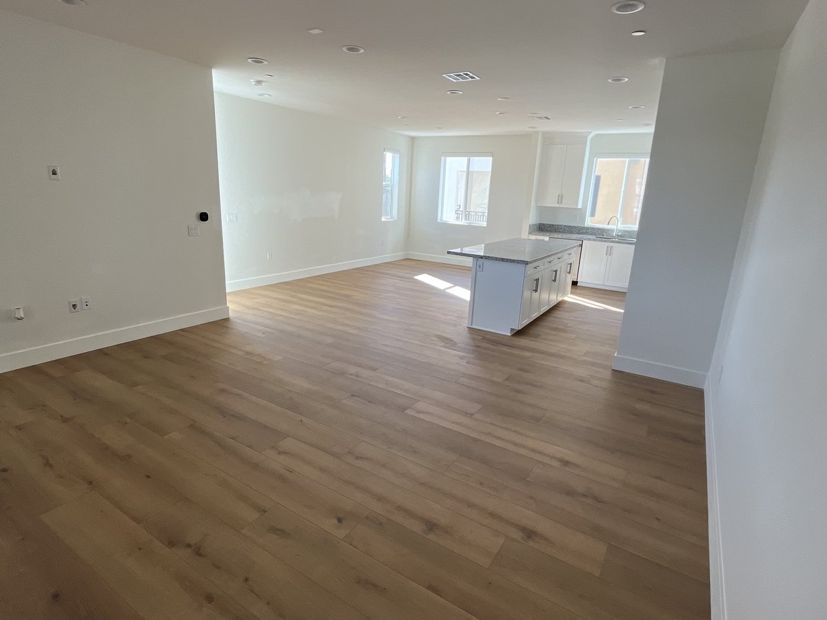 After: new wood-look flooring installed in the living room and kitchen