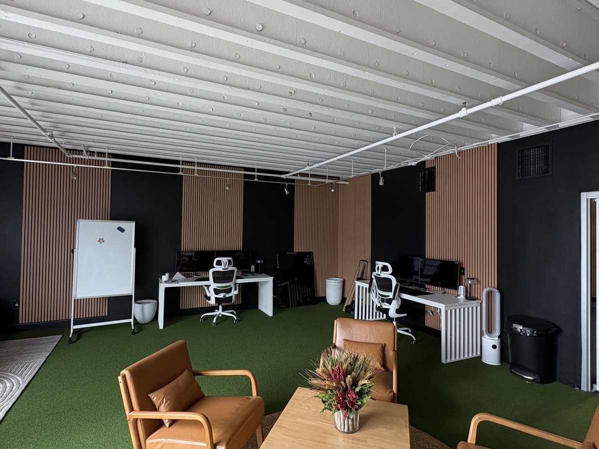 After: finished commercial space with custom wood-slat accent walls and furniture