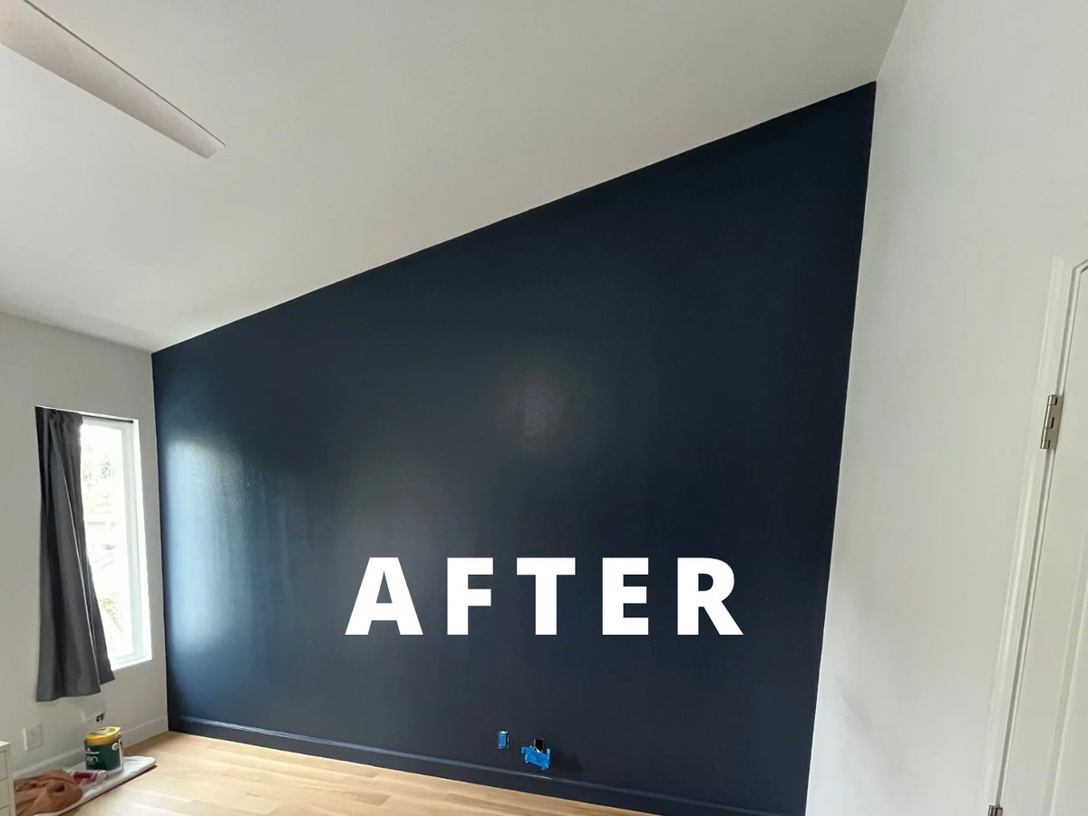After: bedroom accent wall painted in a deep navy blue