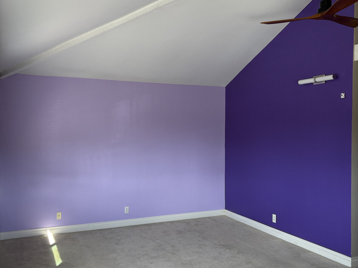 After: accent wall repainted in a bold purple