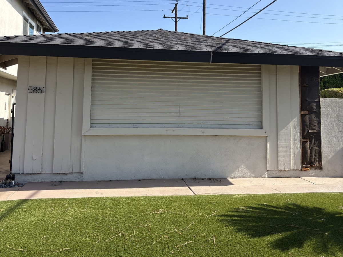 Before: original worn wood siding and stucco wall