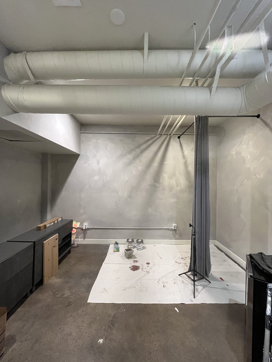 Surface preparation in progress before painting, with drop cloth and supplies staged