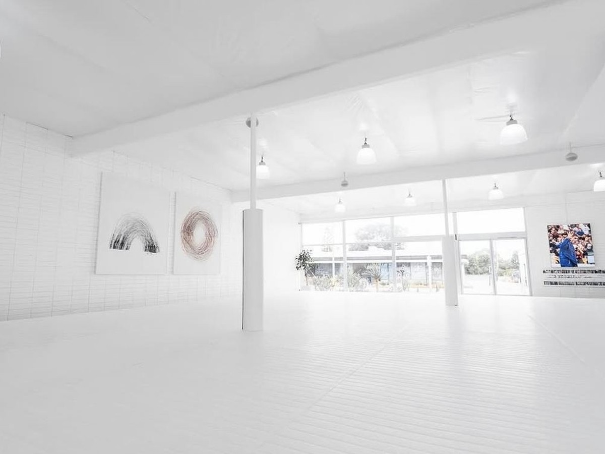 Bright, fully repainted interior space with clean white walls, ceiling and floor