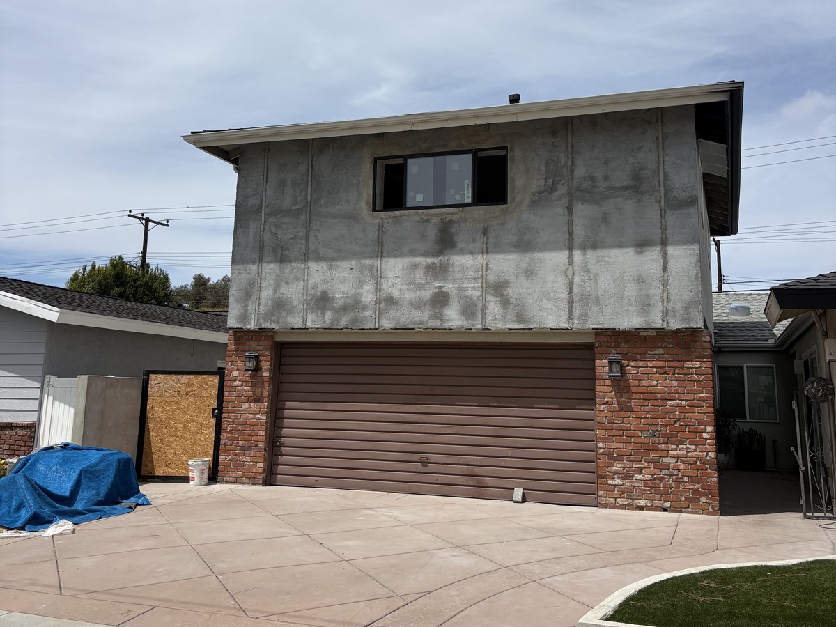 House with a full stucco re-coat and a new stamped concrete driveway