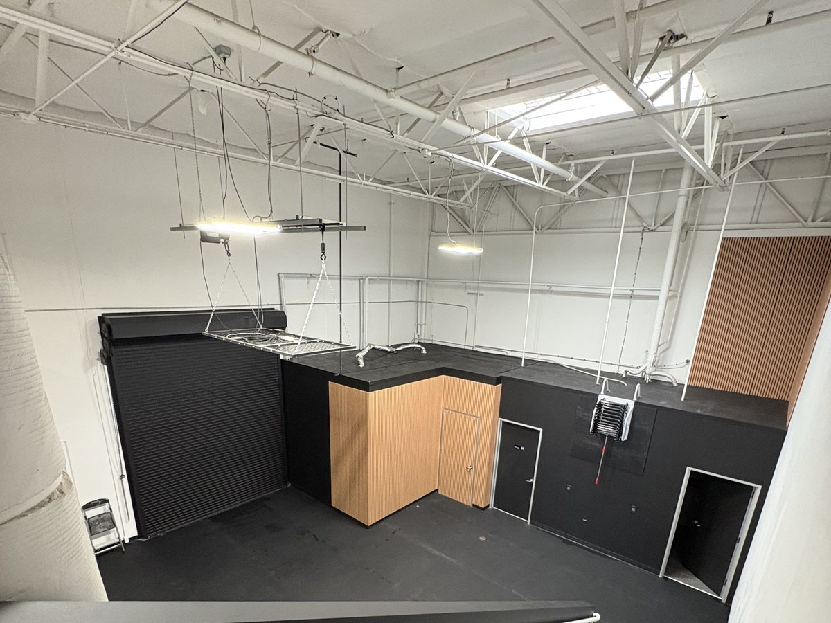 Custom-built mezzanine storage loft with plywood decking