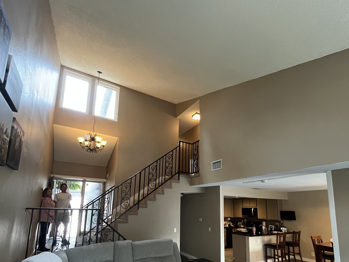New flooring at the base of a two-story foyer staircase