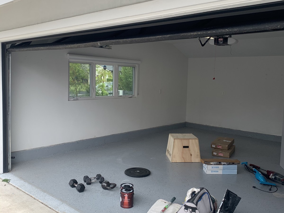 Before: empty garage with white walls used for storage
