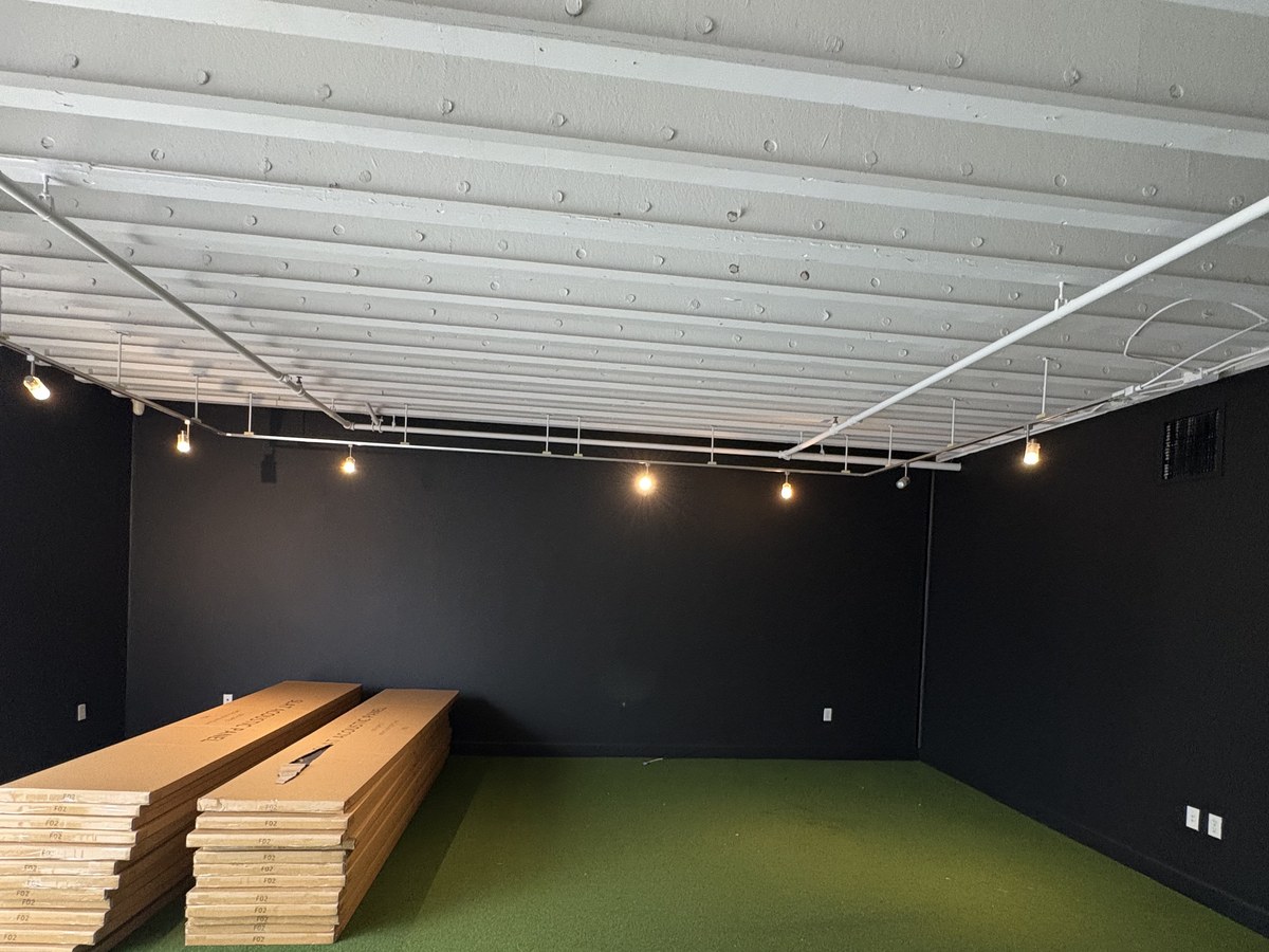 Garage storage room with turf flooring, materials staged for the next phase