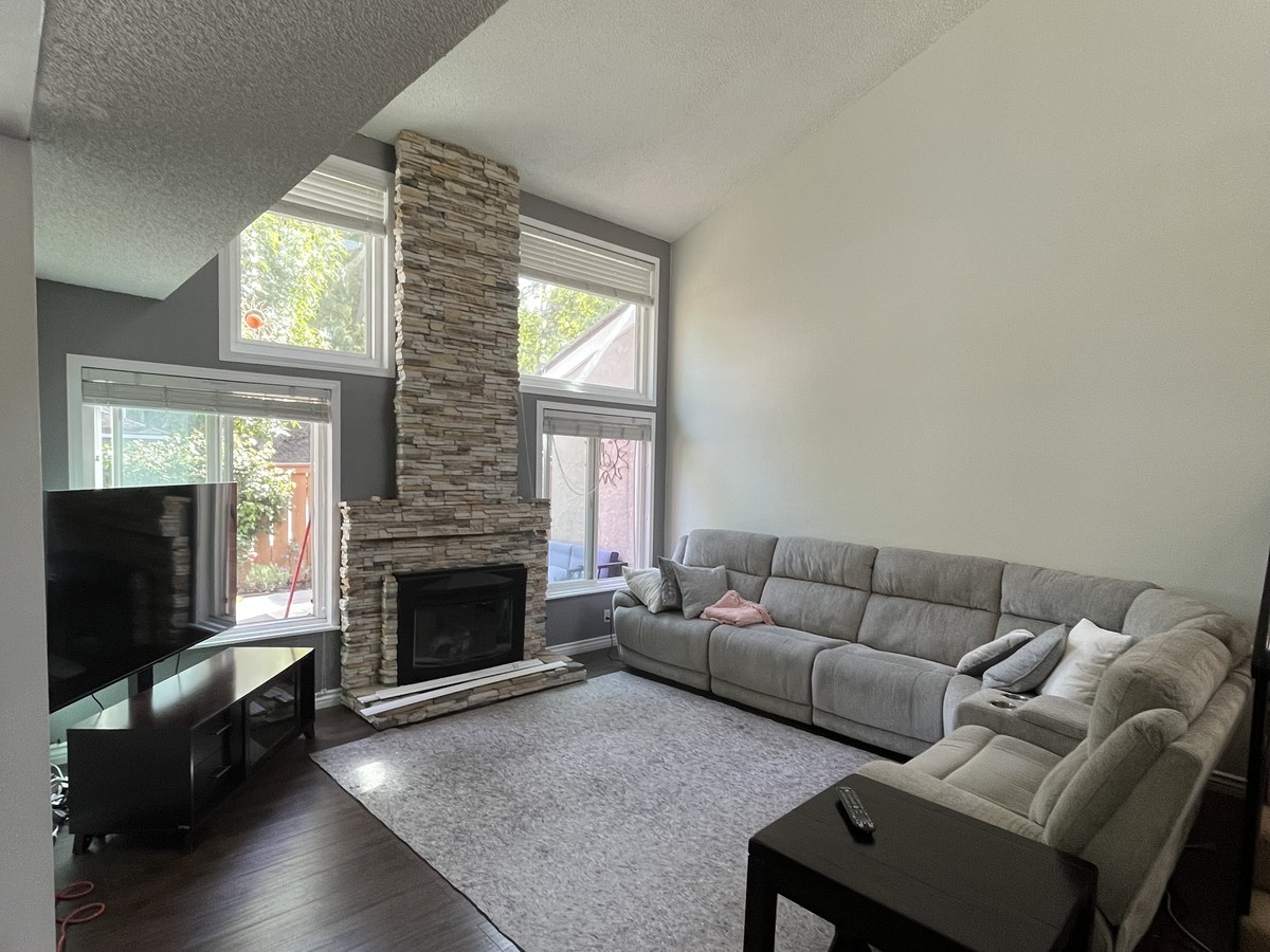 Living room with a stone fireplace, second view