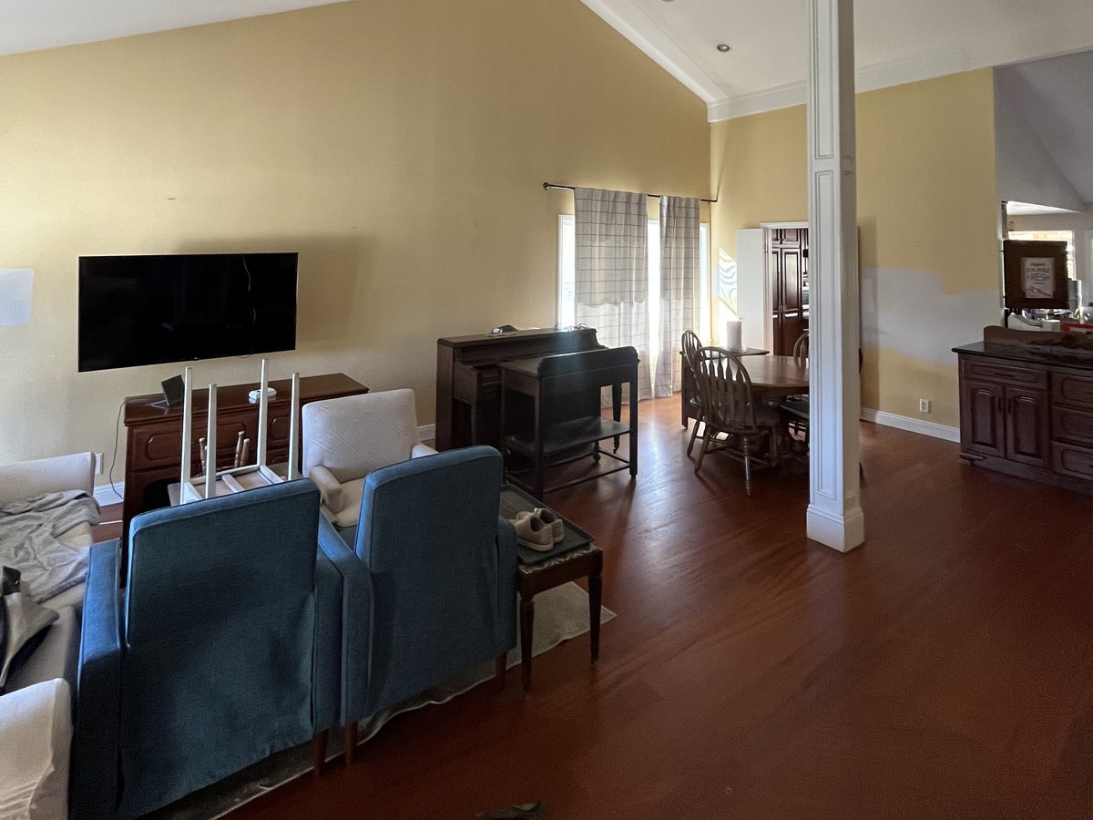 Living room being prepped for painting, furniture cleared from the walls